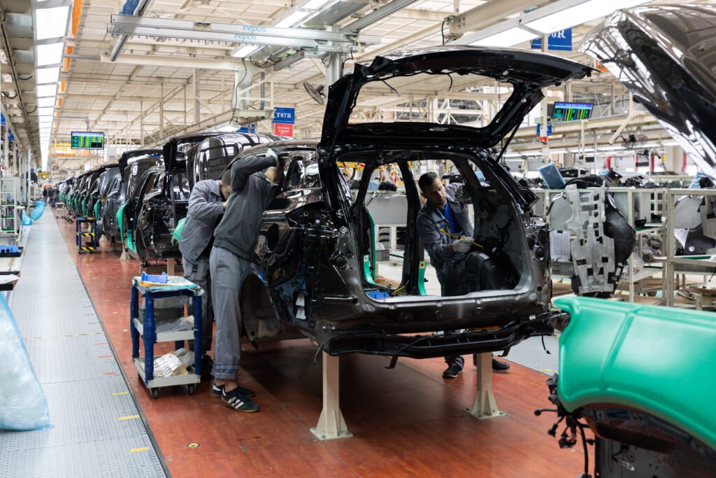 car bodies are on assembly line. factory for production of cars. modern automotive industry. a car being checked before being painted in a high tech enterprise